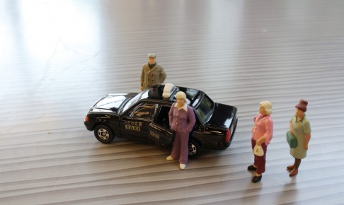 A,Small,Human,Figure,And,A,Japan,Taxi