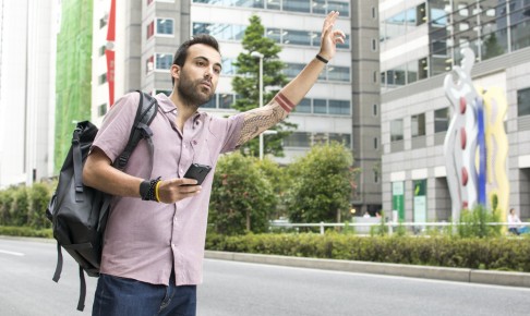 Young,White,Man,Holding,Cellphone,Hailing,Uber,Taxi
