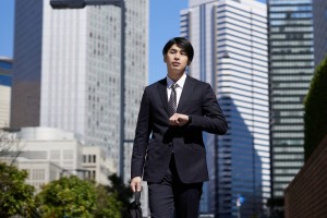 A,Japanese,Male,Businessman,Walks,Through,An,Office,District.