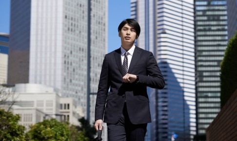 A,Japanese,Male,Businessman,Walks,Through,An,Office,District.