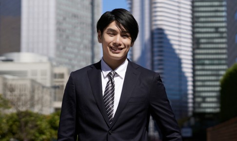 A,Smiling,Japanese,Male,Businessman,Stands,In,An,Office,District.
