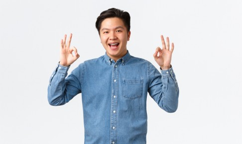 Smiling,Satisfied,Asian,Man,With,Braces,In,Blue,Shirt,,Showing