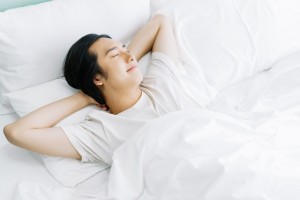 Top,View,Of,Young,Asian,Man,Smiling,While,Sleeping,In