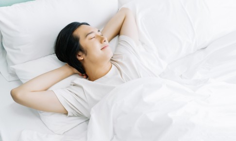 Top,View,Of,Young,Asian,Man,Smiling,While,Sleeping,In