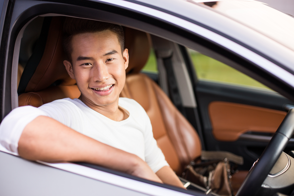 Portrait,Of,An,Handsome,Smiling,Asian,Business,Man,Driving,His