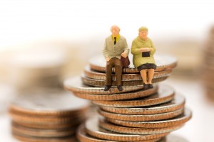 Miniature,People,,Old,Couple,Figure,Sitting,On,Top,Of,Stack