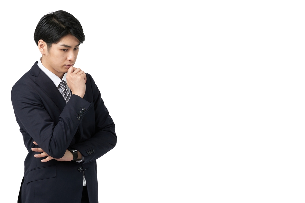 Asian,Businessman,Thinking,With,His,Arms,Crossed